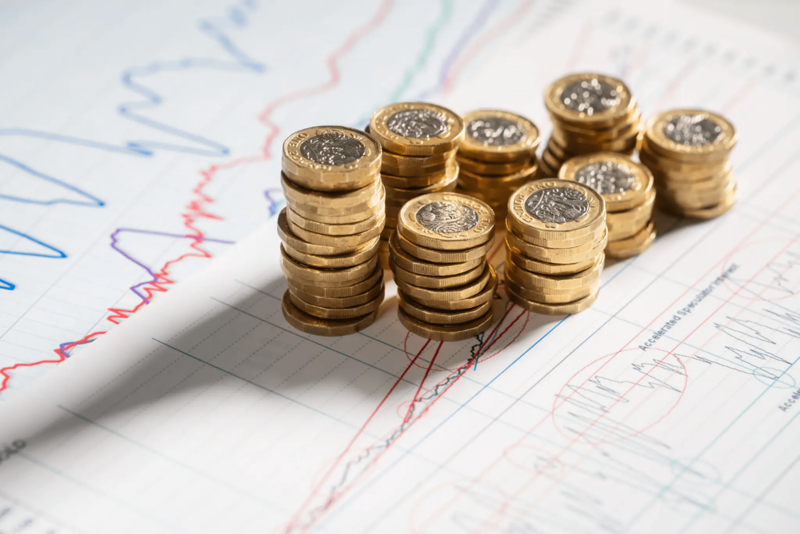 67ec00c90e7d3_blob-ac8c979 A pile of coins sitting on top of a paper.